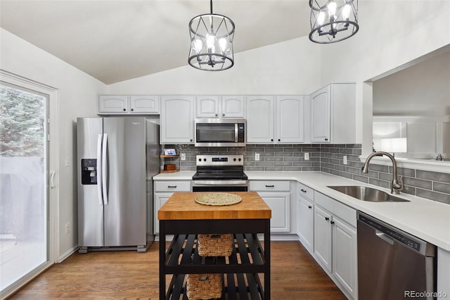 12753 Buckhorn Creek St, Parker, CO 80134 - kitchen with appliances with stainless steel finishes, a sink, a chandelier, lofted ceiling, and tasteful backsplash