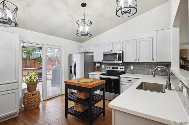 12753 Buckhorn Creek St, Parker, CO 80134 - kitchen with appliances with stainless steel finishes, a chandelier, a sink, vaulted ceiling, and decorative backsplash