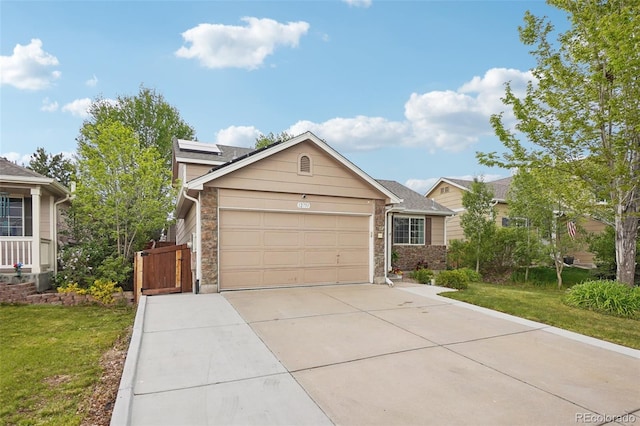 12753 Buckhorn Creek St, Parker, CO 80134 - view of front of home featuring concrete driveway, an attached garage, a front lawn, and stone siding