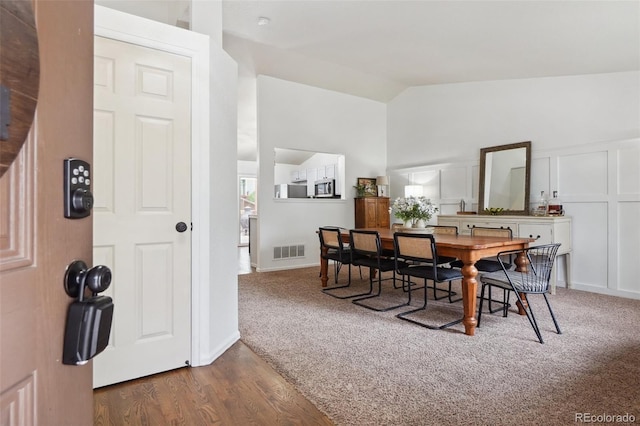 12753 Buckhorn Creek St, Parker, CO 80134 - dining area featuring vaulted ceiling and wood finished floors