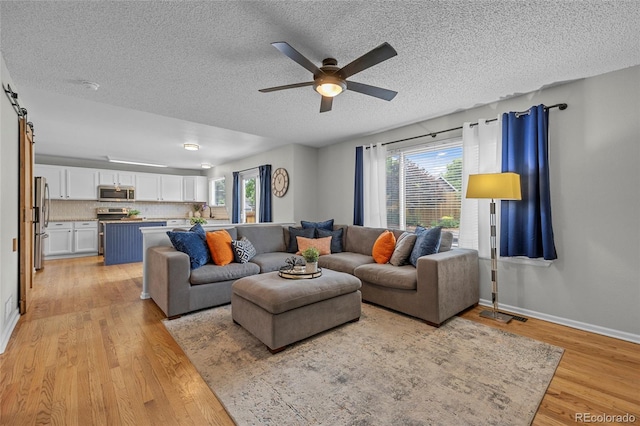 11188 Latigo Ln, Parker, CO 80138 - living area featuring light wood finished floors, a ceiling fan, a textured ceiling, and baseboards