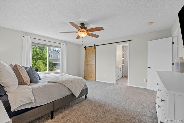 11188 Latigo Ln, Parker, CO 80138 - bedroom with a barn door, light carpet, a textured ceiling, ceiling fan, and baseboards