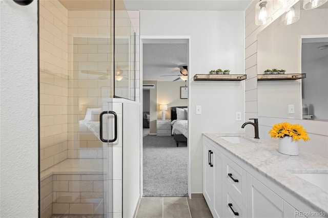 11188 Latigo Ln, Parker, CO 80138 - full bath featuring connected bathroom, ceiling fan, double vanity, a shower stall, and tile patterned floors