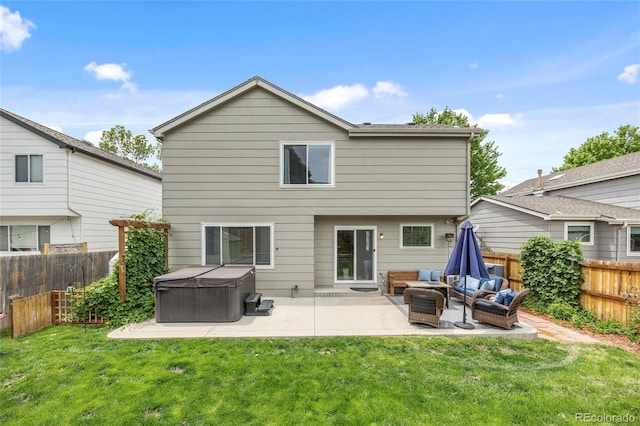 11188 Latigo Ln, Parker, CO 80138 - back of house featuring a hot tub, a patio, and an outdoor hangout area