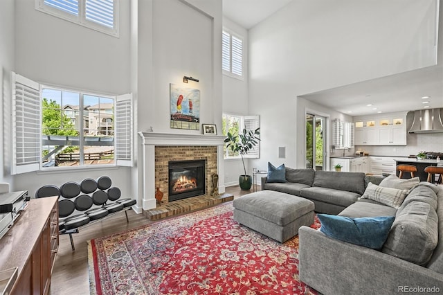 2090 Bellavista St, Castle Rock, CO 80109 - living room featuring a towering ceiling, wood finished floors, a fireplace, and baseboards