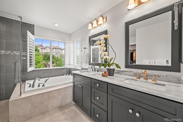 2090 Bellavista St, Castle Rock, CO 80109 - bathroom featuring double vanity, a bath, tile patterned floors, tiled shower, and recessed lighting