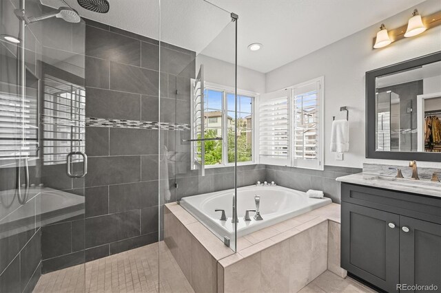2090 Bellavista St, Castle Rock, CO 80109 - full bath featuring vanity, a stall shower, a bath, tile patterned flooring, and recessed lighting