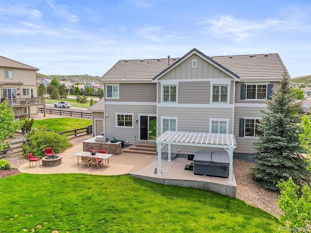 2090 Bellavista St, Castle Rock, CO 80109 - rear view of house with an outdoor fire pit, board and batten siding, and a patio