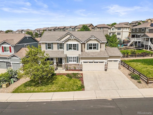 2090 Bellavista St, Castle Rock, CO 80109 - view of front of property with a residential view, concrete driveway, stone siding, and a garage