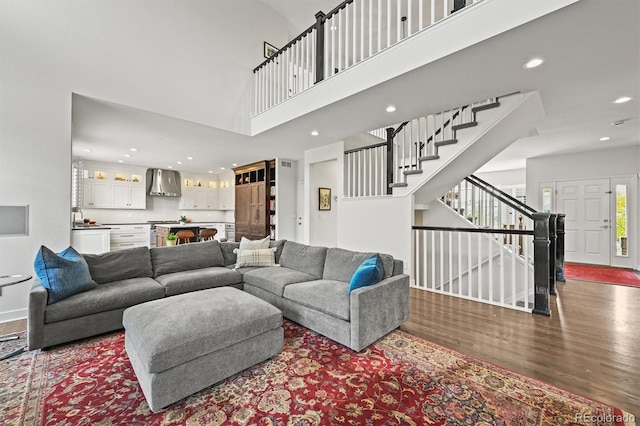 2090 Bellavista St, Castle Rock, CO 80109 - living area with wood finished floors, stairway, recessed lighting, a high ceiling, and baseboards
