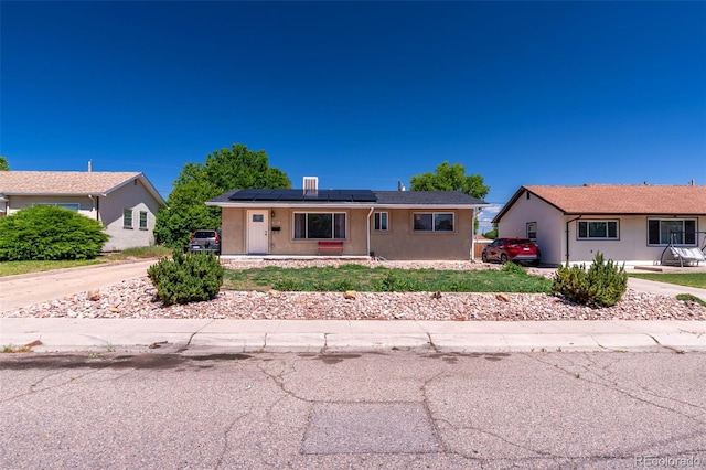 1611 Englewood Dr, Pueblo, CO 81005 - ranch-style house with solar panels and stucco siding