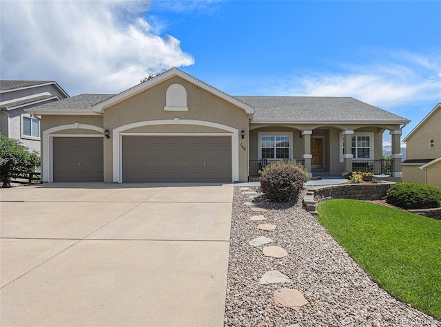 149 Walters Creek Dr, Monument, CO 80132 - view of front of house featuring an attached garage, concrete driveway, stucco siding, and covered porch