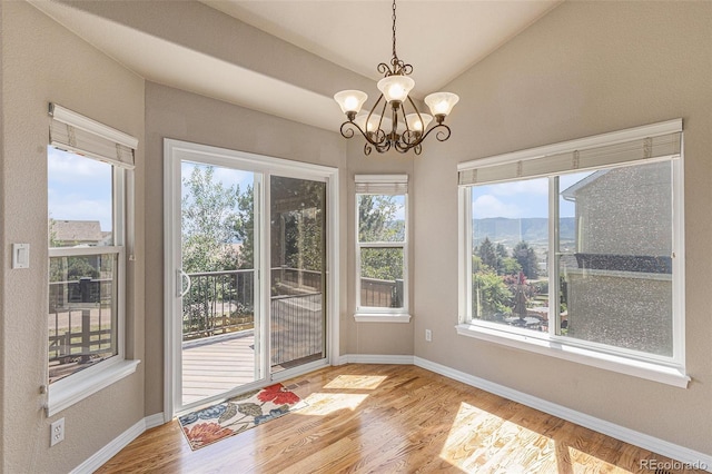 149 Walters Creek Dr, Monument, CO 80132 - unfurnished sunroom with plenty of natural light, a chandelier, and vaulted ceiling