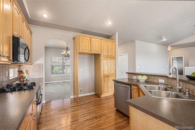 149 Walters Creek Dr, Monument, CO 80132 - kitchen with black microwave, stainless steel dishwasher, dark countertops, gas cooktop, and dark wood-style floors