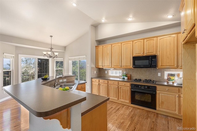 149 Walters Creek Dr, Monument, CO 80132 - kitchen featuring black appliances, dark countertops, lofted ceiling, a chandelier, and tasteful backsplash