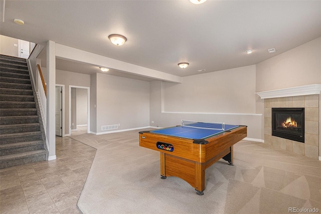 149 Walters Creek Dr, Monument, CO 80132 - rec room featuring a tiled fireplace, light tile patterned floors, billiards table, and light colored carpet