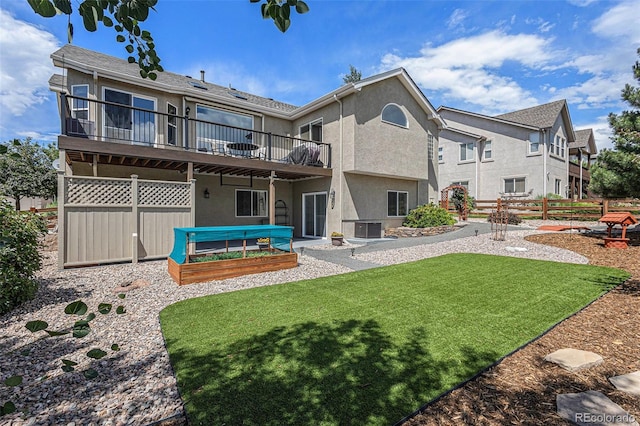 149 Walters Creek Dr, Monument, CO 80132 - back of house featuring stucco siding, a wooden deck, and a garden