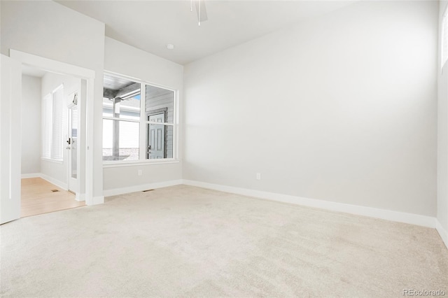 empty room with carpet flooring and ceiling fan