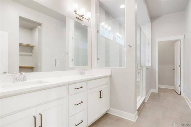 bathroom featuring walk in shower, tile patterned flooring, and vanity