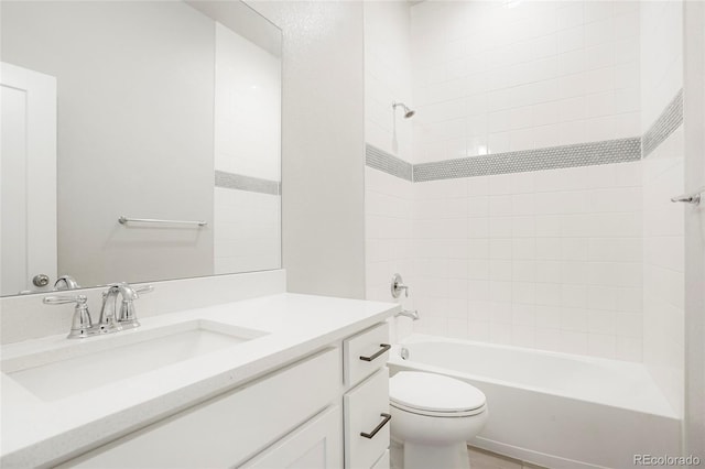 full bathroom featuring toilet, vanity, and tiled shower / bath combo