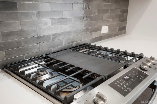 details with backsplash and gas stove