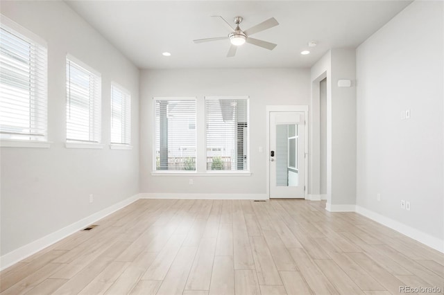 empty room with light wood-type flooring and ceiling fan