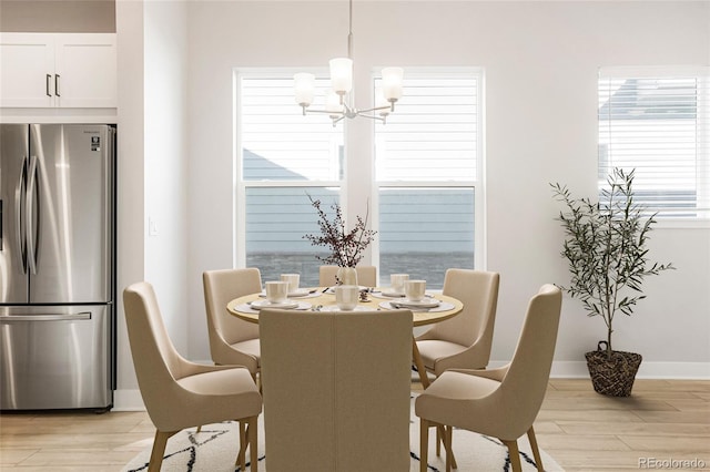 dining room featuring an inviting chandelier and light hardwood / wood-style floors