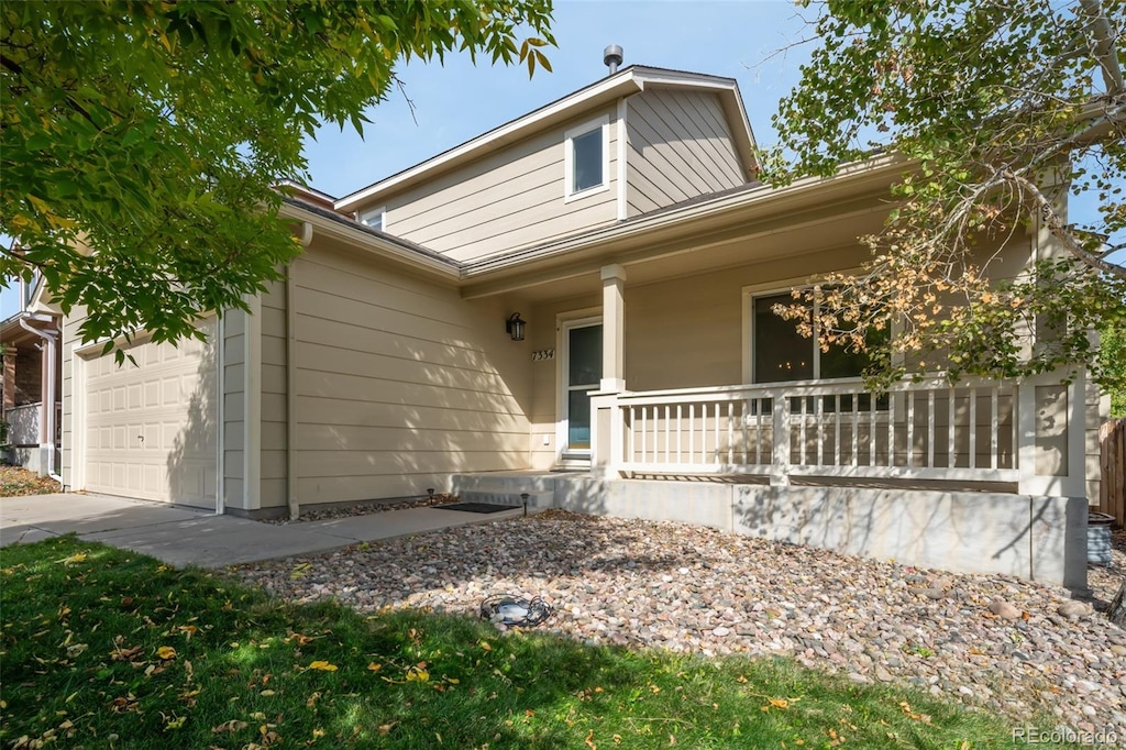 view of front of home with covered porch and a garage