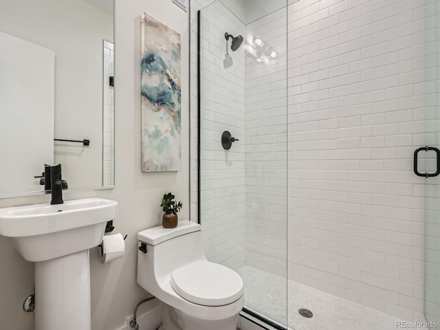 bathroom with a shower stall and toilet