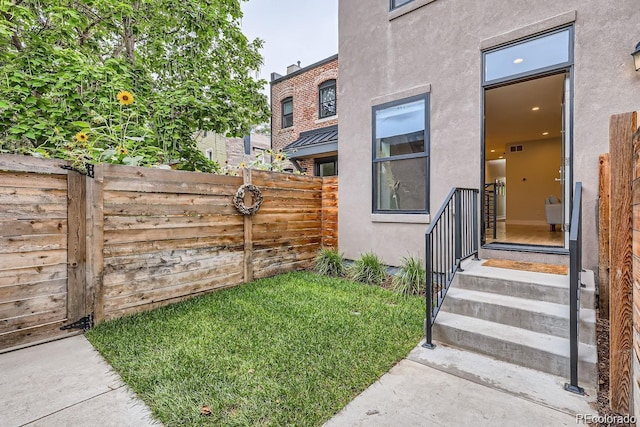 doorway to property featuring fence and stucco siding