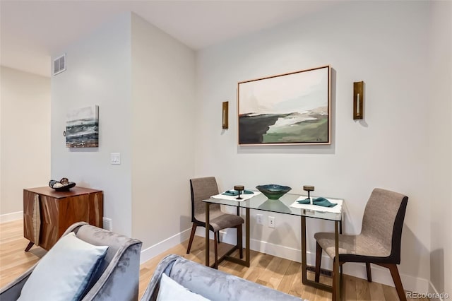 interior space featuring visible vents, baseboards, and wood finished floors