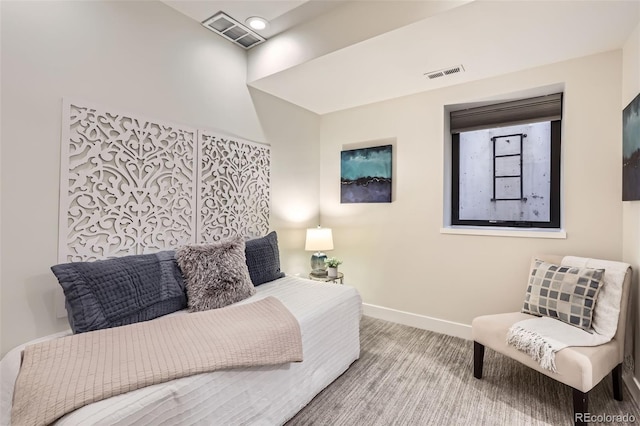 carpeted bedroom with baseboards and visible vents