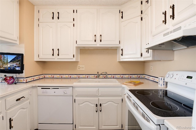 kitchen with premium range hood, white cabinetry, sink, and white appliances