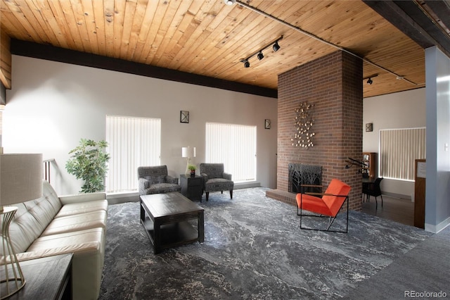 living room with a fireplace, track lighting, and wooden ceiling