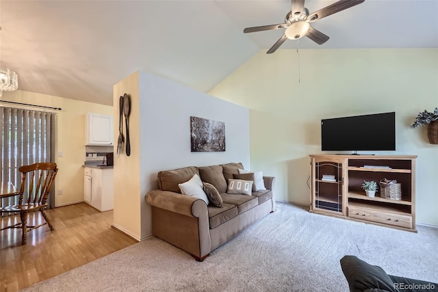 9627 Franklin St, Thornton, CO 80229 - living area featuring ceiling fan, lofted ceiling, a chandelier, light colored carpet, and light wood-type flooring