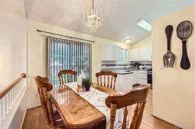 9627 Franklin St, Thornton, CO 80229 - dining space featuring lofted ceiling, light wood finished floors, and a chandelier