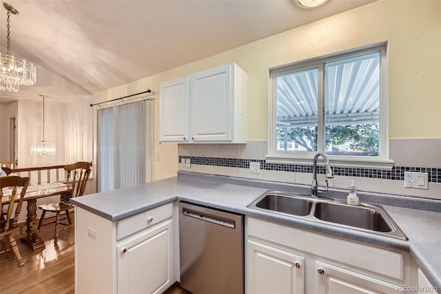 9627 Franklin St, Thornton, CO 80229 - kitchen featuring dishwasher, a chandelier, white cabinets, lofted ceiling, and tasteful backsplash