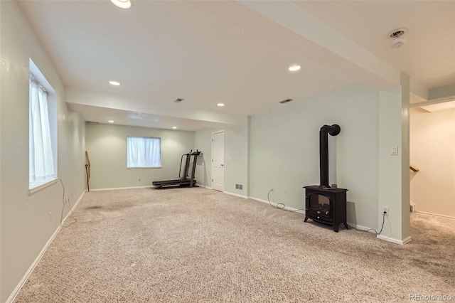 9627 Franklin St, Thornton, CO 80229 - below grade area with carpet floors, a wood stove, and recessed lighting