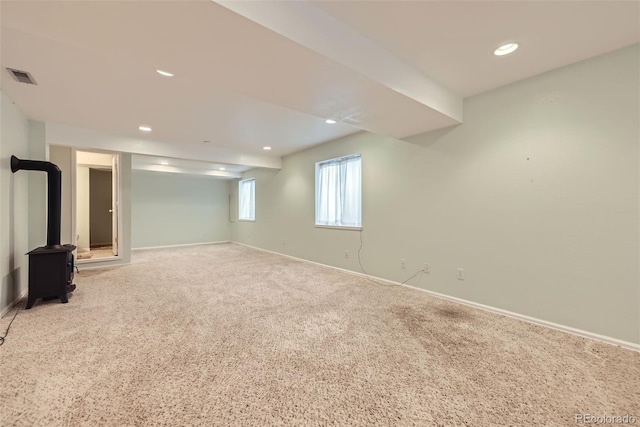 9627 Franklin St, Thornton, CO 80229 - below grade area featuring light colored carpet, recessed lighting, and a wood stove