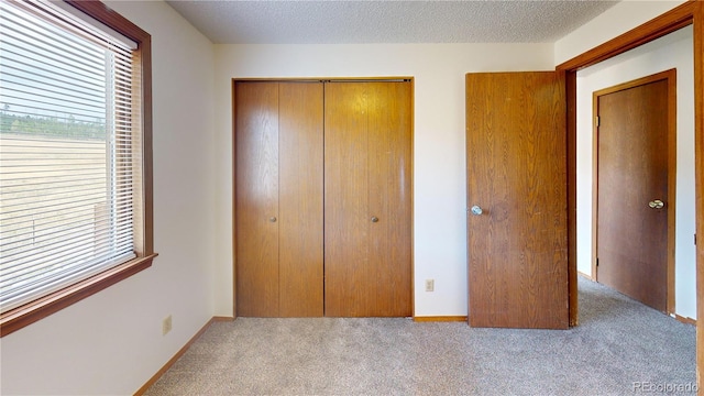 290 Castello Ave, Fairplay, CO 80440 - unfurnished bedroom featuring carpet floors, a closet, multiple windows, and a textured ceiling