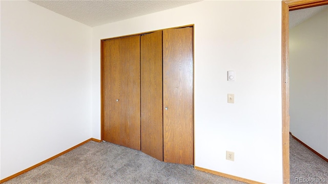 290 Castello Ave, Fairplay, CO 80440 - unfurnished bedroom with carpet floors, a closet, and a textured ceiling