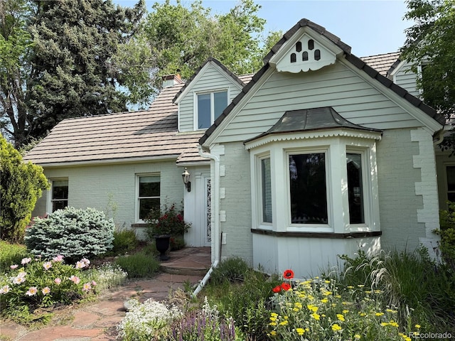 6375 E 6th Avenue Parkway, Denver, CO 80220 - view of front facade featuring brick siding and a chimney