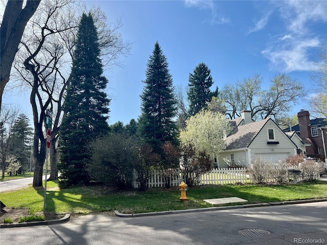 6375 E 6th Avenue Parkway, Denver, CO 80220 - view of property exterior featuring a garage and a chimney