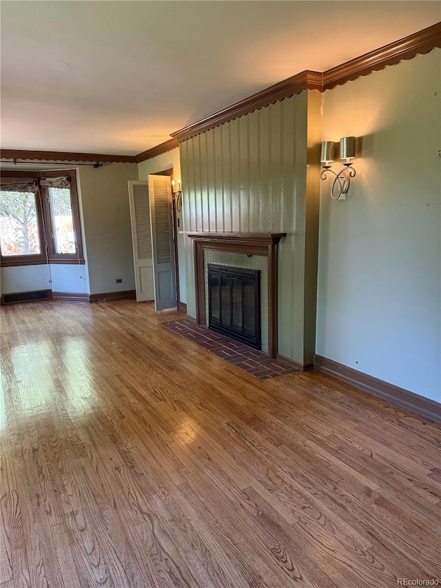 6375 E 6th Avenue Parkway, Denver, CO 80220 - unfurnished living room featuring wood finished floors, ornamental molding, and a glass covered fireplace