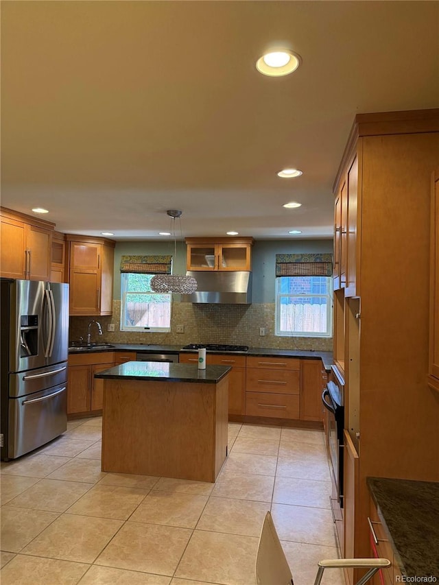 6375 E 6th Avenue Parkway, Denver, CO 80220 - kitchen featuring appliances with stainless steel finishes, under cabinet range hood, healthy amount of natural light, tasteful backsplash, and recessed lighting