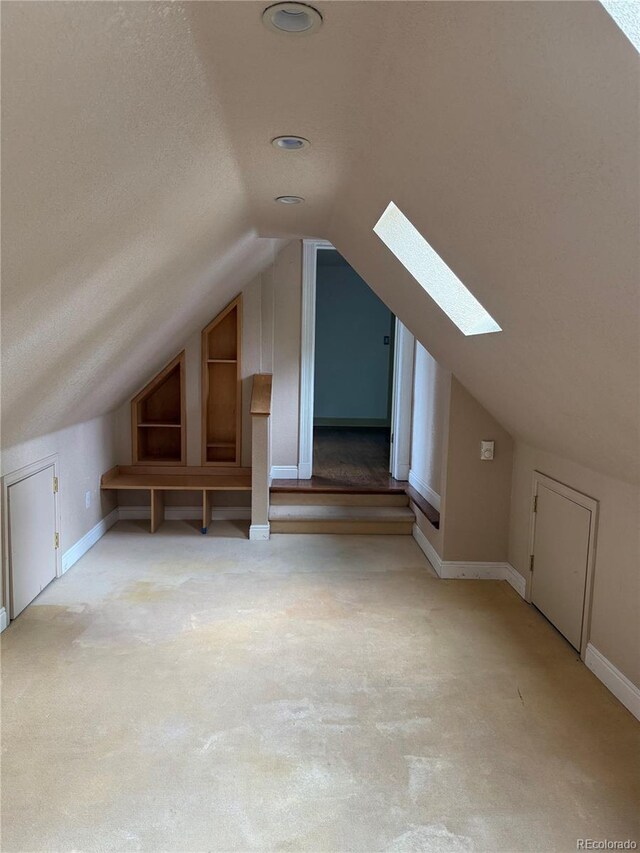 6375 E 6th Avenue Parkway, Denver, CO 80220 - additional living space with a skylight, carpet floors, and lofted ceiling