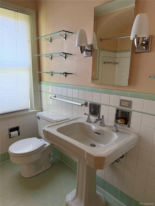 6375 E 6th Avenue Parkway, Denver, CO 80220 - bathroom with tile walls, tile patterned flooring, and a wainscoted wall