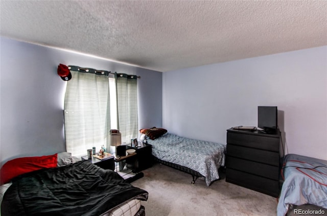 carpeted bedroom with a textured ceiling