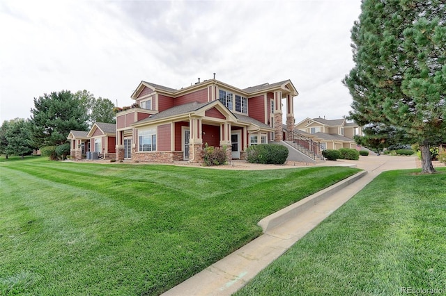 view of front of home featuring stone siding and a front lawn