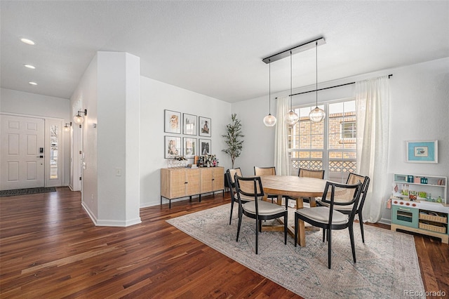 dining space featuring dark wood-style floors, a textured ceiling, recessed lighting, and baseboards